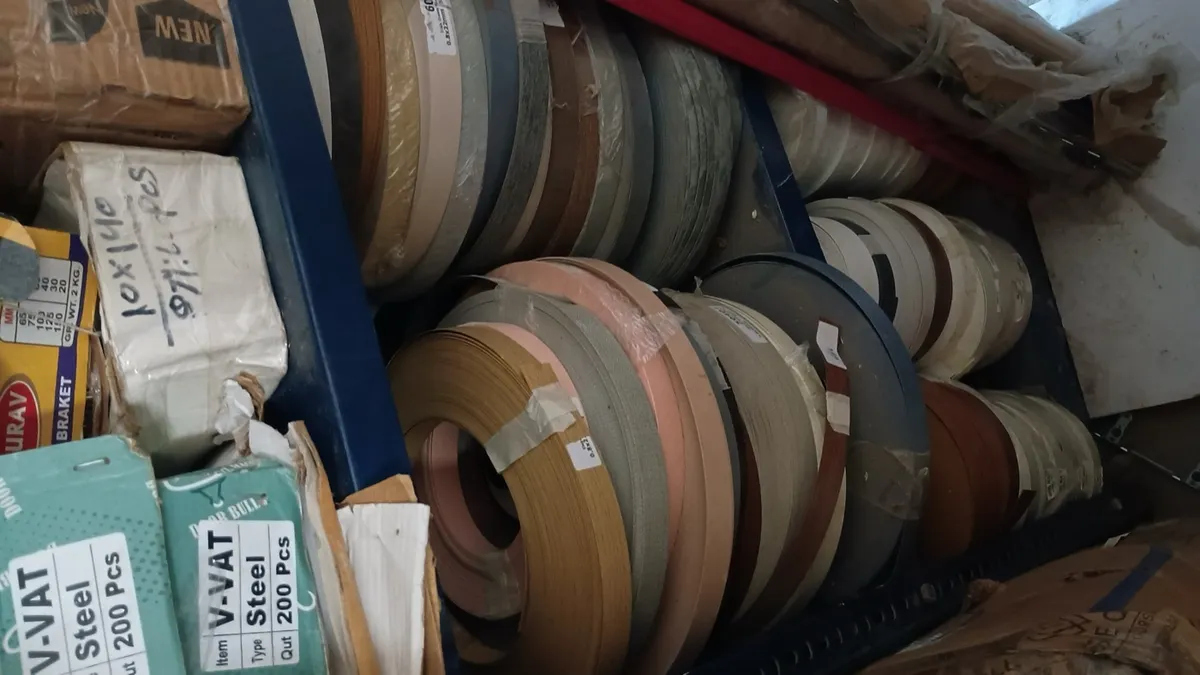 Rolls of edge-banding tape in different colours and wood tones
